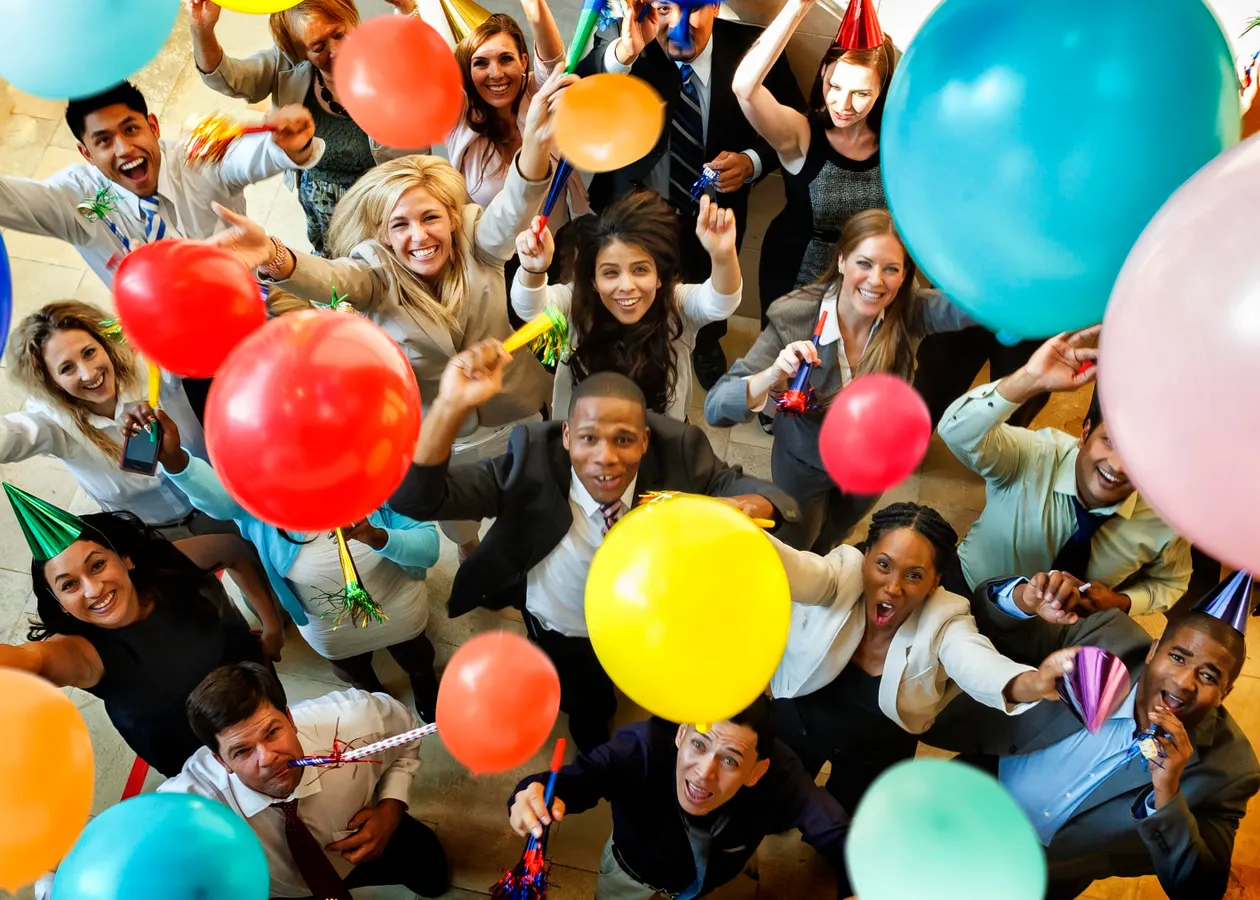 Corporate team celebrating with balloons