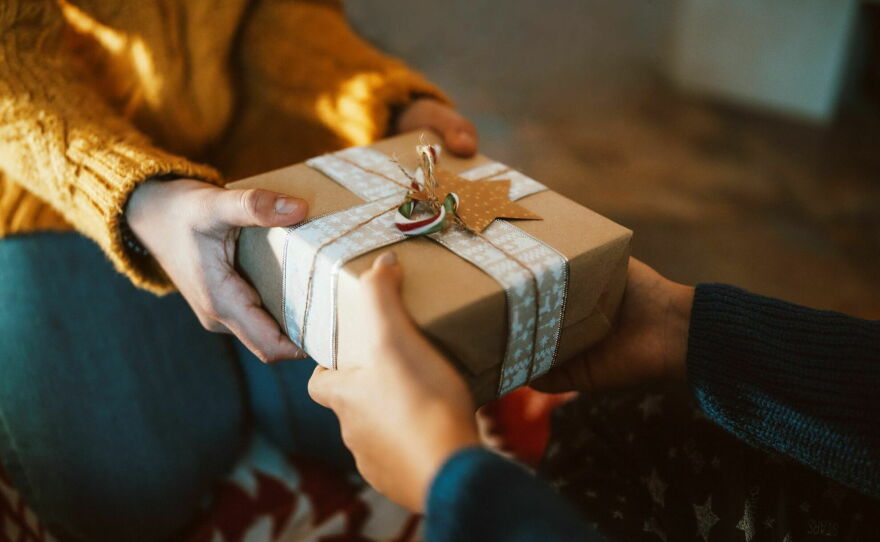 Gift box being handed over as a thoughtful surprise